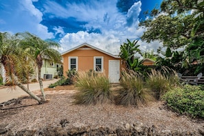A single-story house with a beige exterior, a white door, and a number '451' on the front. - Charming Newly Reno 1 min to Downtown Dunedin (Dunedin)