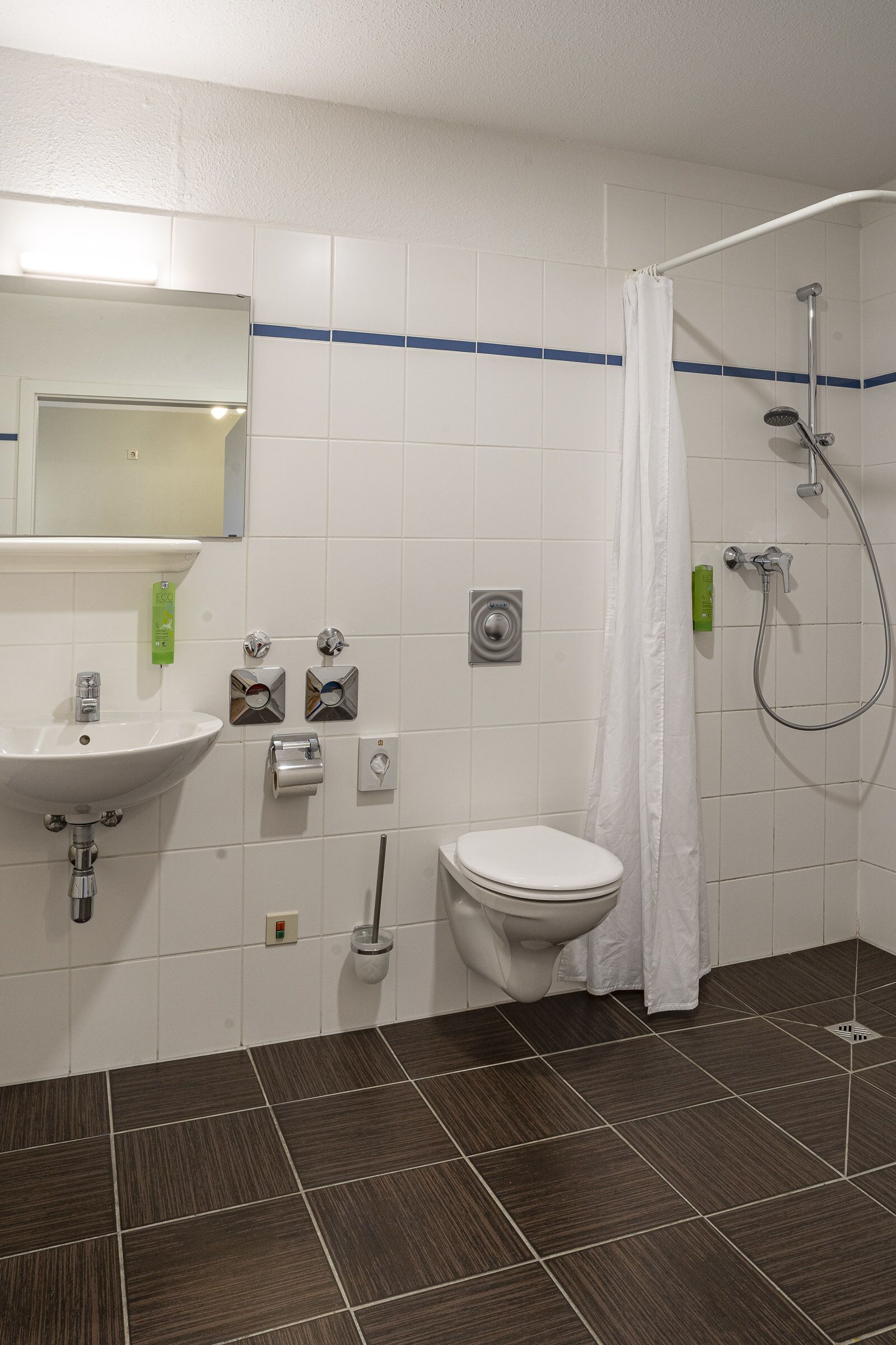 A bathroom with a sink, toilet, and shower.