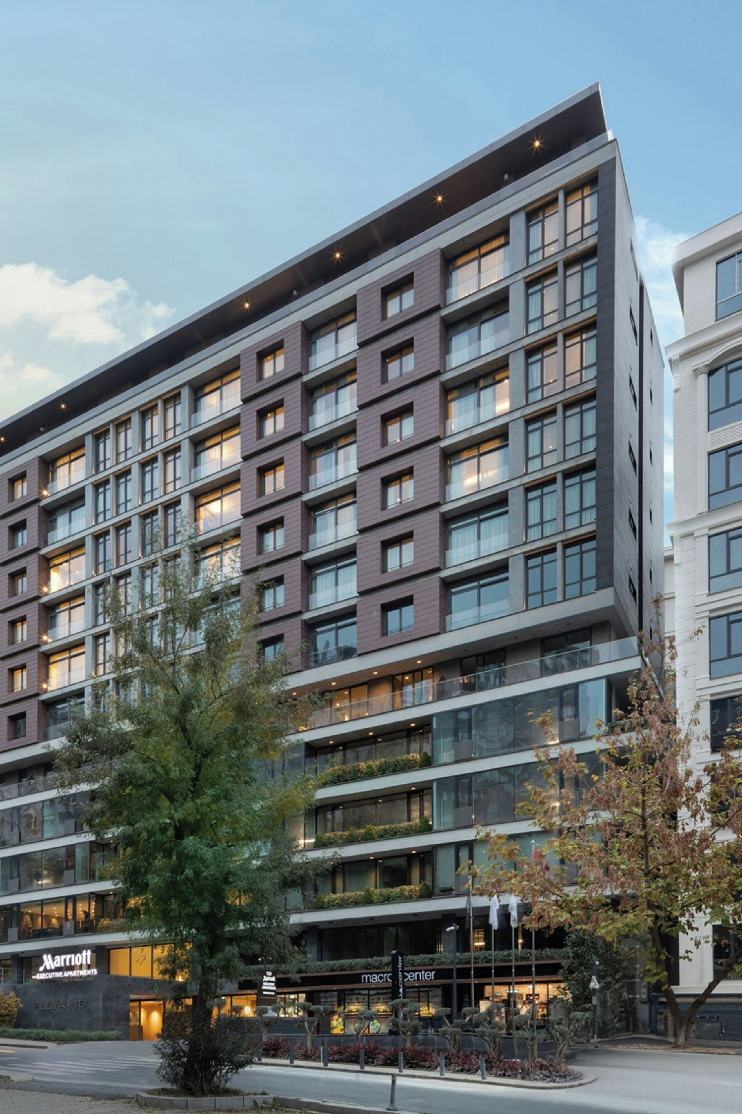 A multi-story hotel with a modern architectural design, featuring a mix of glass and solid facade elements.