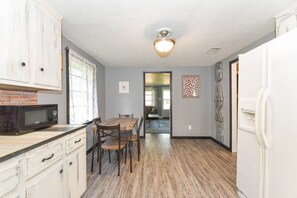 Full-size fridge, stovetop, dishwasher, coffee/tea maker