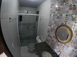 Un baño con ducha, inodoro y lavamanos.
