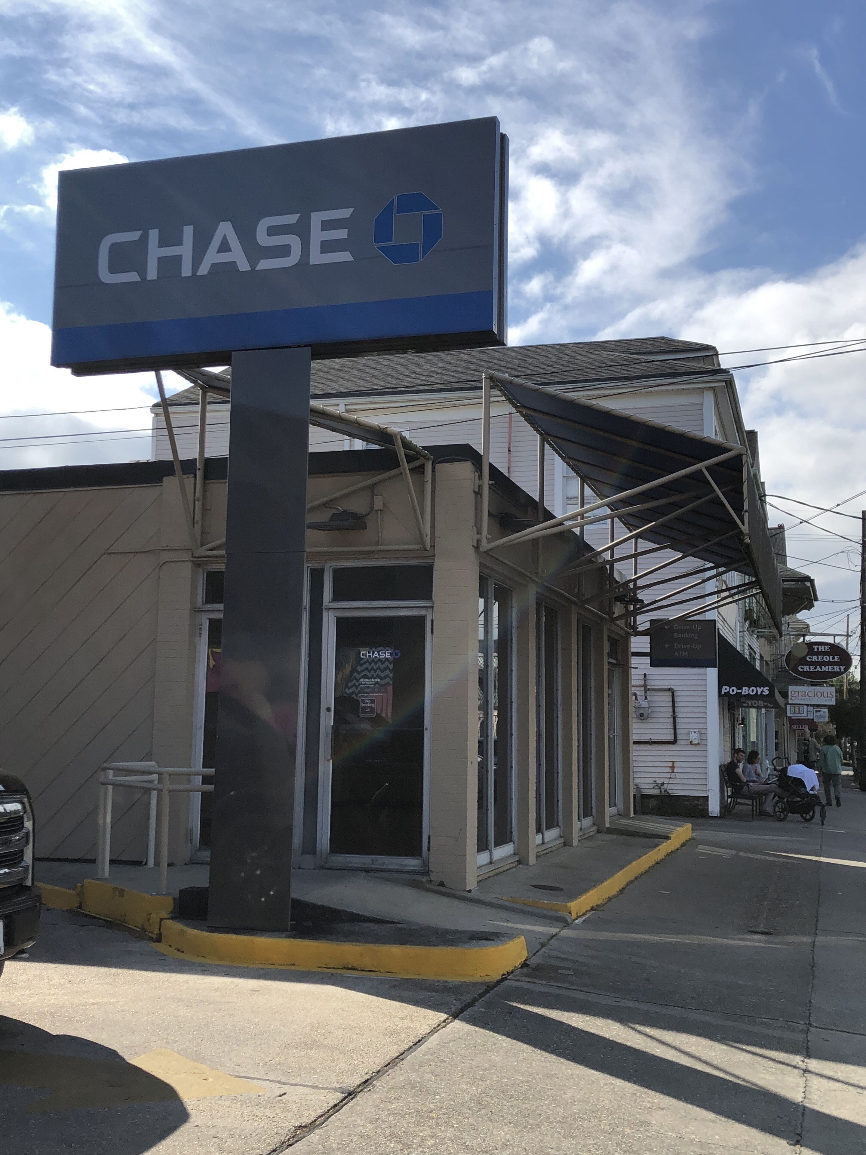 A commercial building with a 'CHASE' sign, a drive-up window, and a 'The Creole Creamery' sign.