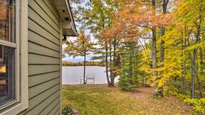A house with a view of a lake and autumn foliage. - Cozy Hayward Cottage w/ Dock & Lakefront View (Hayward)