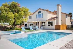 A two-story house with a swimming pool, outdoor seating, and a large tree. - Luxury 5BR\4BA House with Pool & Spa close to Vegas Strip (Las Vegas)