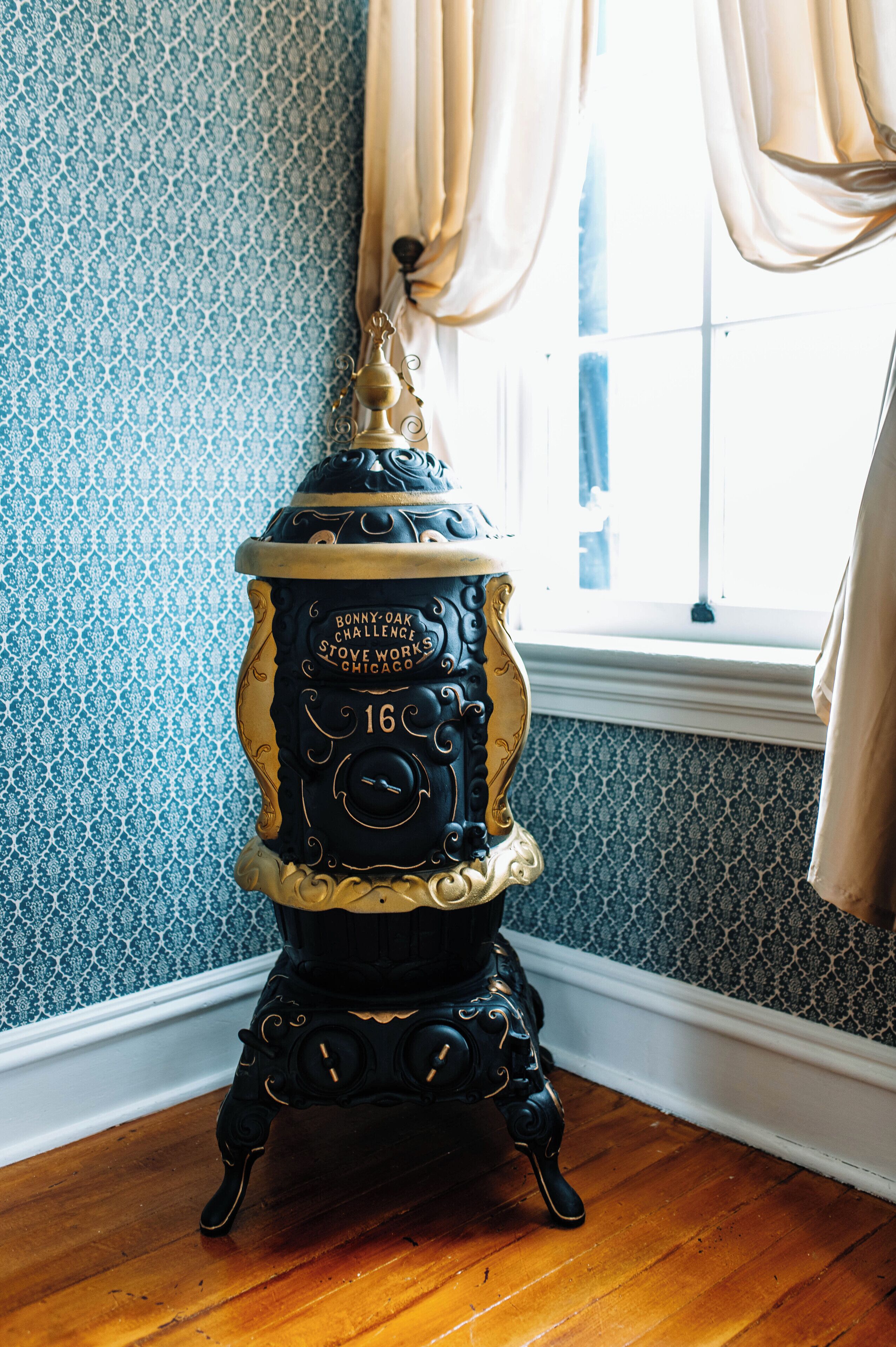 A vintage stove with intricate designs and a label that reads "Bonny Oak Challenge Stove Works Chicago."