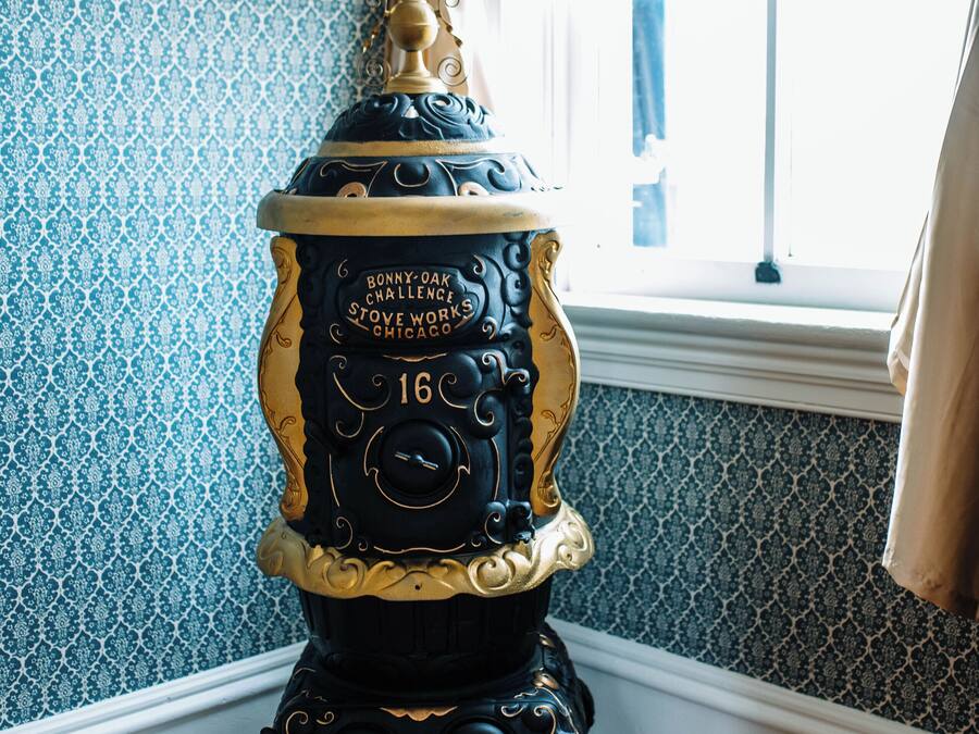 A vintage stove with intricate designs and a label that reads "Bonny Oak Challenge Stove Works Chicago."