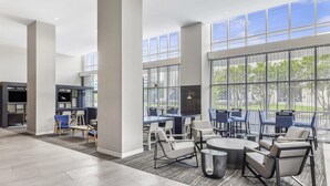 A spacious indoor area with high ceilings, large windows, and modern furniture. - Hyatt Place Houston Medical Center (Houston)