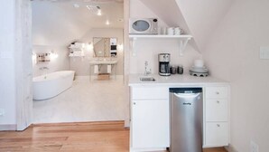 A modern bathroom with a bathtub, a sink, and a mirror.