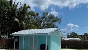 A swimming pool with a covered area and a patio. - Lovely 1 Bedroom with a Pool (Jupiter)