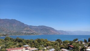 A coastal landscape with a clear view of the sea and mountains in the distance.