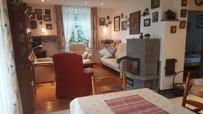 Cozy living room with a fireplace, comfortable seating, and dining area, perfect for relaxing and socializing.
