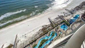 A beach resort with a water slide, a pool, and a beach area. - Phoenix West 2207 Upscale Luxury | Updated | Beachfront | Waterslide-Lazy River (Orange Beach)