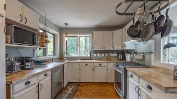 Enjoy cooking in this well-equipped kitchen with a central island, sink, and ample counter space.