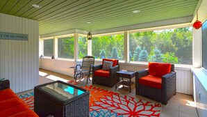 A sunlit porch with wicker furniture, a glass coffee table, and a vibrant rug. - 9 Bedroom Estate, Sleeps 24, Pool, Hot Tub, Movie Theater, Game Room (Newry)
