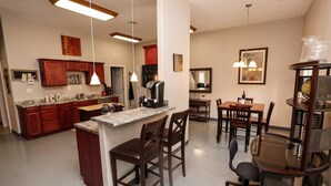 A spacious kitchen with a central island, wooden cabinets, and pendant lighting. - Convenient Mountain Comfort (Lincoln)