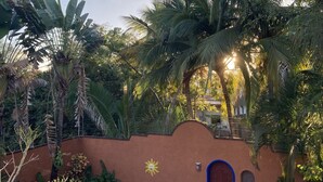 A rustic building with a brown wall, a blue door, and a sun decoration. - Casa Fiesta, Best Place to Rest, 1 Block Away From the Beach Owner Managed (Rincón de Guayabitos)