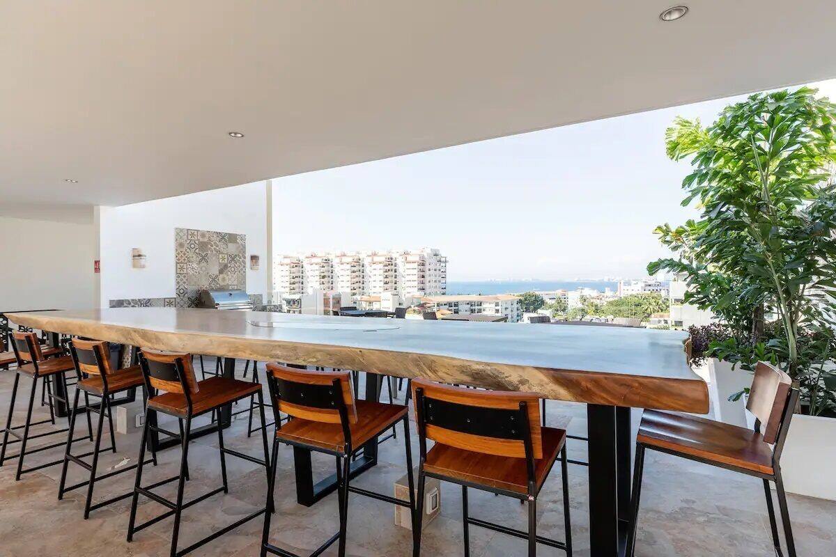 A modern kitchen with a large island and bar seating.