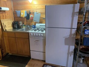Enjoy cooking in this fully equipped kitchen with a refrigerator, gas stove, oven, and sink.