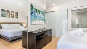 A hotel room with two beds, a large mirror, and artwork on the walls. - The Sand Resort Kingscliff - One Bed Pool view (3302) (Tweed)