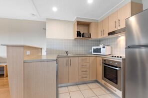 Fridge, microwave, oven, stovetop - The Pool Resort Kingscliff - 1 BR Small Pool View (7204) - Holiday Management Co. (Tweed)