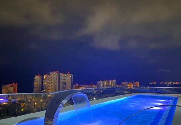 A rooftop pool with a city skyline in the background. - CONDO NAUTICO BY TRVL2HM (Puerto Vallarta)