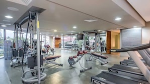 A gym with treadmills, weight machines, and free weights. - CONDO NIM BY TRVL2HM (Puerto Vallarta)