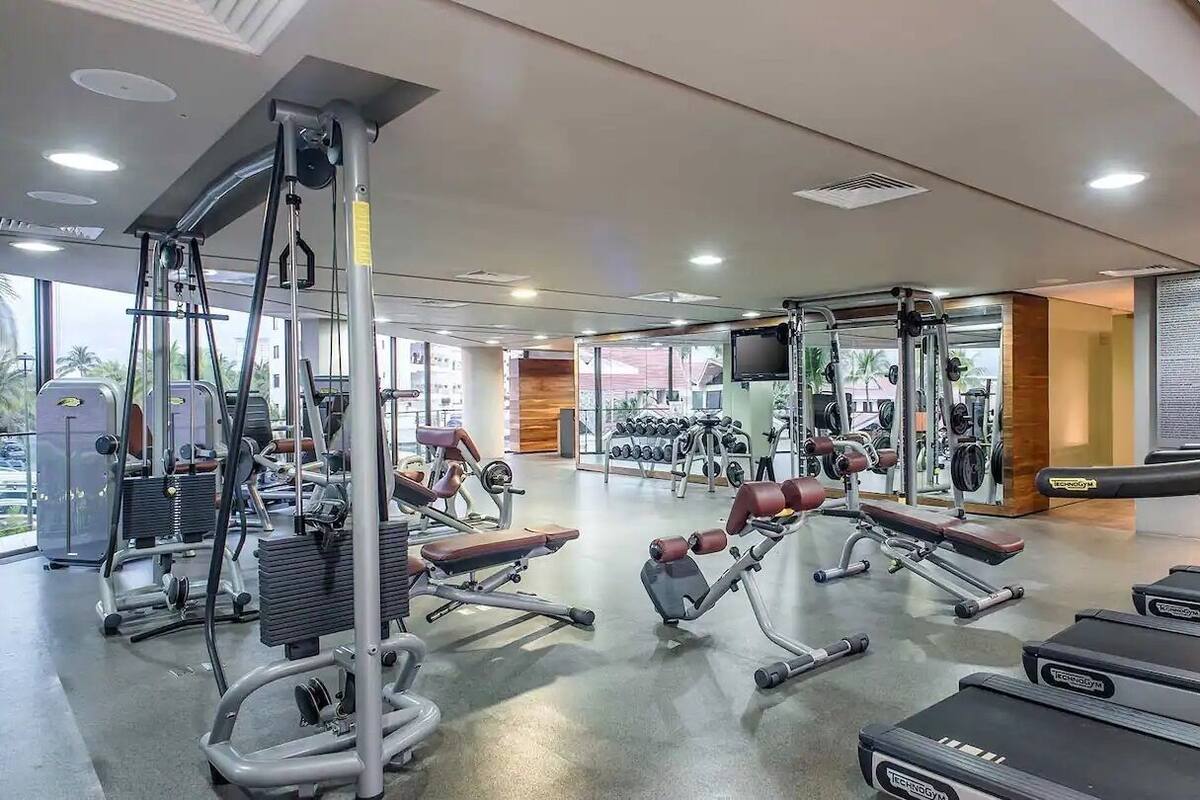 A gym with treadmills, weight machines, and free weights.