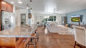 A modern kitchen with a granite island, stainless steel appliances, and pendant lighting. - Casa Bonita with Private Pool / 4B/2B sleeps 8 in Old Town Scottsdale (Scottsdale)