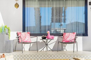 Relax in this inviting outdoor seating area with two comfortable chairs and a small table.