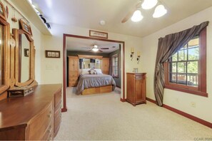 Cozy retreat with a large bed, dresser, and cabinet, offering a comfortable space to rest.