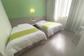 A hotel room with two single beds, a nightstand, a wall-mounted light, and a window with curtains. - House 67, Yandang Mountain (Yueqing)