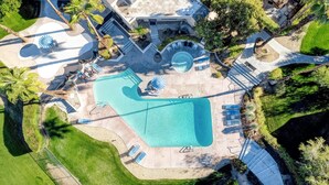 An aerial view of a residential property with a swimming pool, lounge chairs, and a landscaped garden. - Beautifully designed with Mountain View, Resort Amenities, Golf, Office + More (Palm Springs)