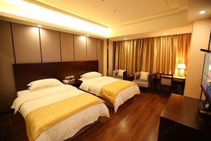 A hotel room with two beds, a desk, a chair, a TV, and a curtain. - Donghu Hotel (Shouning)
