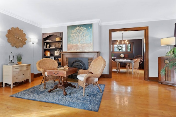 The spacious living room includes a game table flanked by a cozy gas fireplace. Opposite this area is additional seating and a 50" TV.