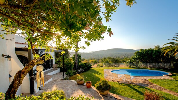 A backyard with a swimming pool, potted plants, and a stone patio. - Suite Swimming Pool Quinta da Eira 140 years old (Loule)