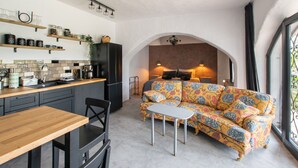A compact living space with a kitchenette, a sofa, and a dining area. - Suite Swimming Pool Quinta da Eira 140 years old (Loule)