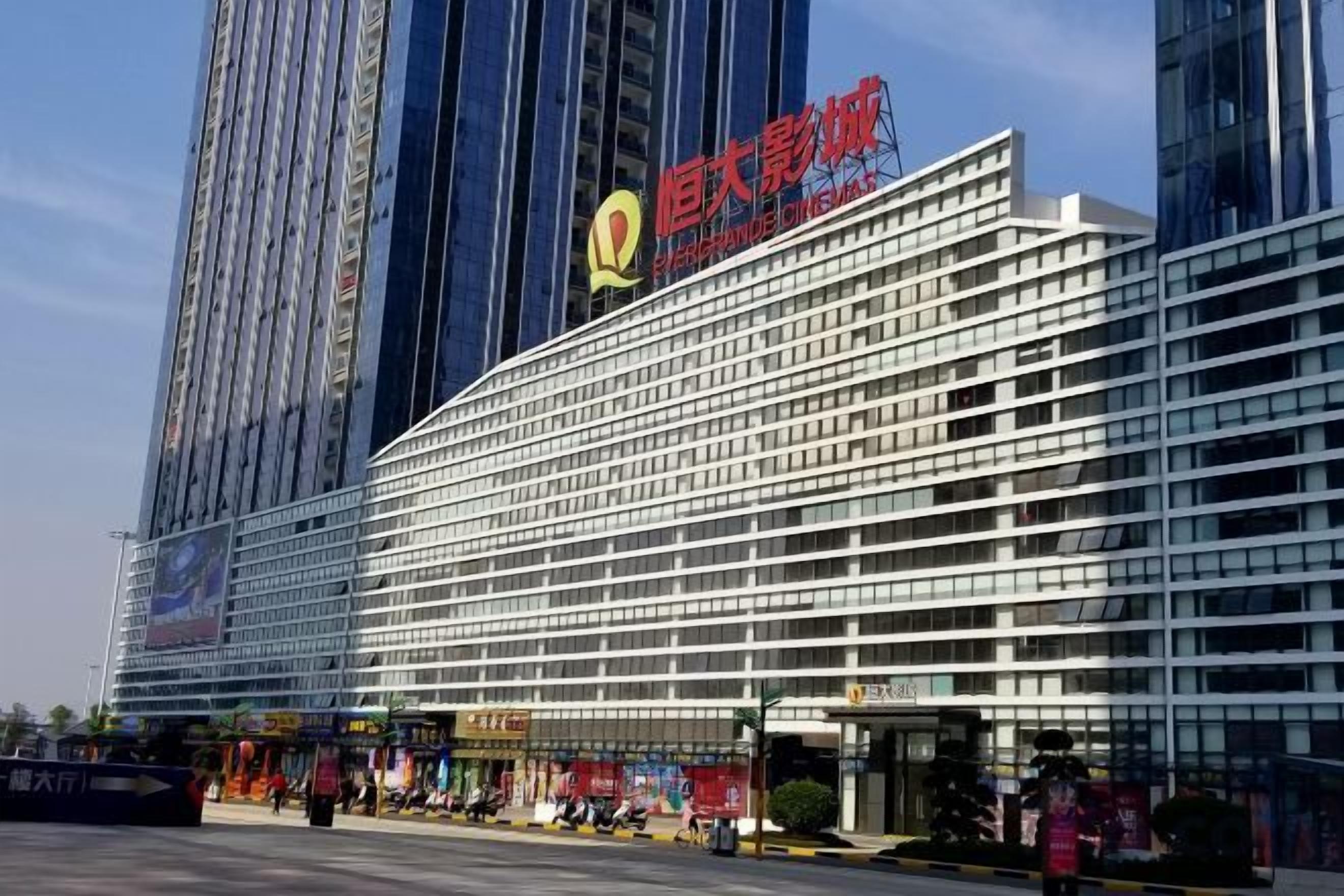 A modern hotel with a prominent horizontal facade, multiple floors, and a large sign indicating it is a hotel.