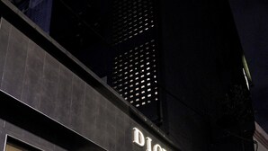 The exterior of the D'Loft Hotel with a modern facade, large glass entrance, and a visible sign. - D Loft Hotel (Kuala Lumpur)