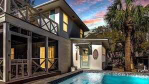 A modern house with a swimming pool, a deck, and a small building with a sign. - Cozy Tybee Getaway on Butler Ave (Tybee Island)