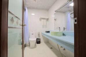 Un baño con inodoro, lavamanos y espejo.