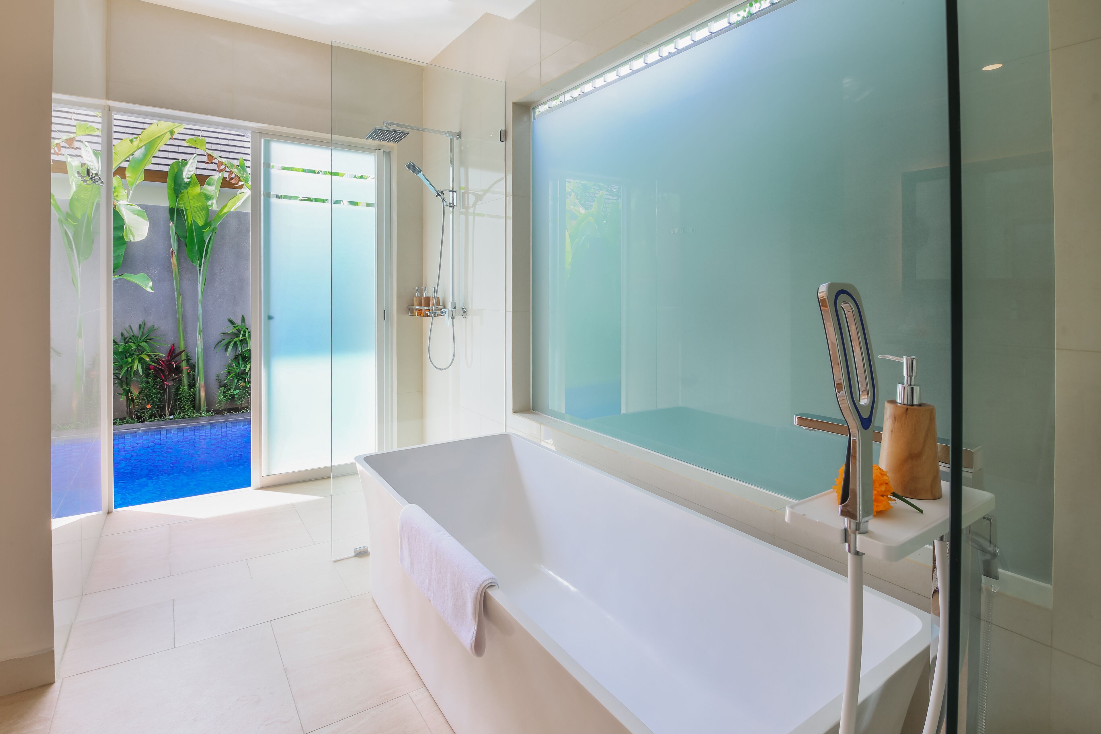 Bathtub, hair dryer, towels, shampoo