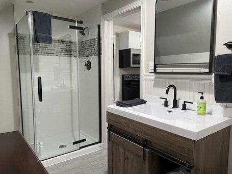 Shower, hair dryer. The Yellow-Shuttered House apt B