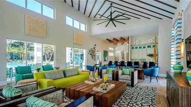 A spacious living area with a bright yellow sofa, multiple seating options, and a modern ceiling design.