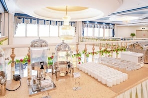 A buffet setup with various food stations, including a coffee machine, a hot beverage dispenser, and a buffet counter with food containers. - Boheng Xitian Hotel (Guiyang)
