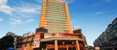 A multi-story hotel with a prominent sign at the top.