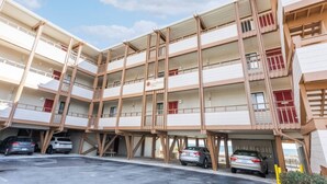 A multi-story parking garage with cars parked inside.