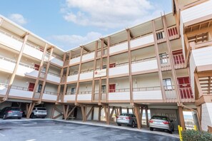 A multi-story parking garage with cars parked inside.