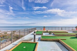A pool table area with a view of the ocean, surrounded by a metal fence. - Hot Tubs & Indoor Pools - First-Floor Privacy (Myrtle Beach)