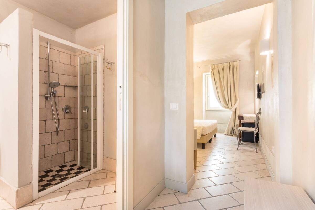 A modern bathroom with a shower, a toilet, and a sink.