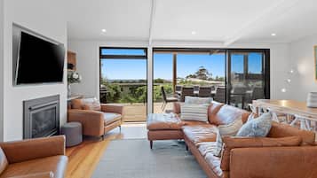 Relax in a stylish living space with a flat-screen TV, fireplace, and comfortable seating area.
